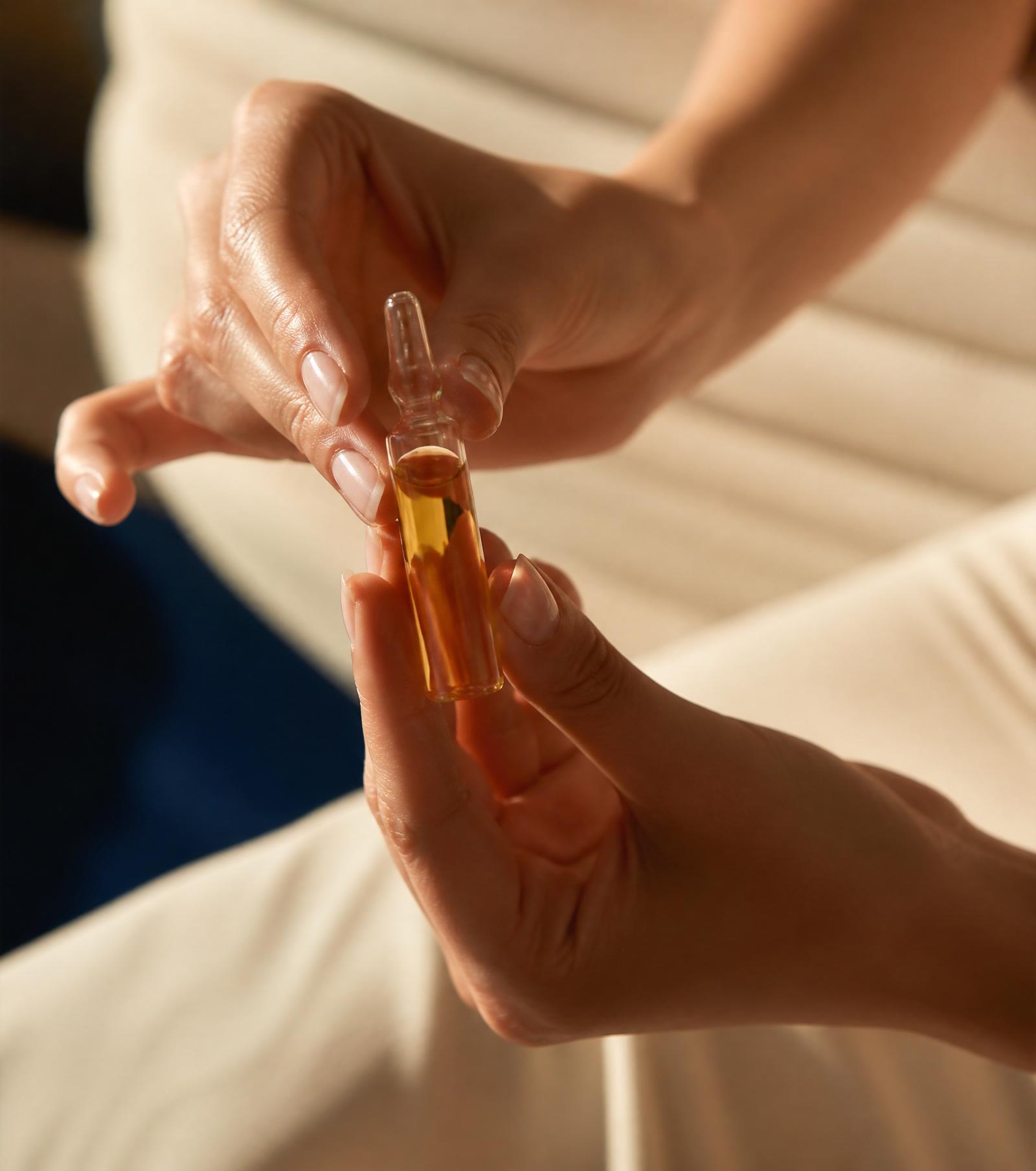 Practitioner holding a wellness vial